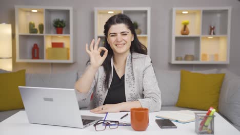 Home-office-worker-woman-making-positive-gesture-at-camera.